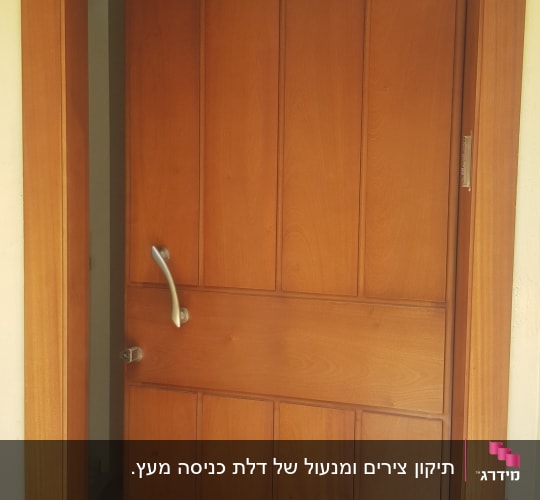 דלת עץ חומה עם ידית מתכת כסופה
